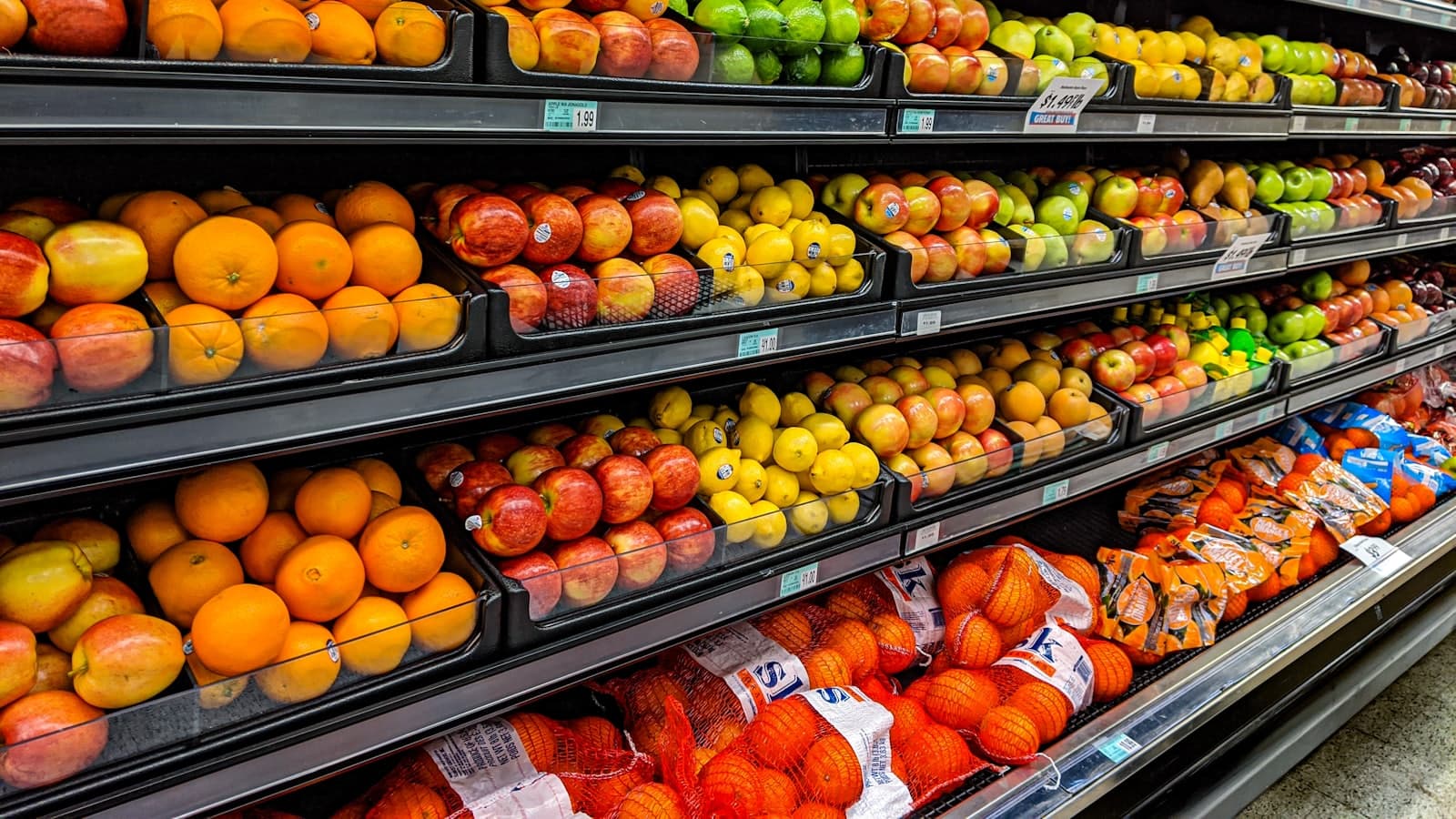 Rayon de supermarché avec des fruits emballés alignés sur plusieurs étagères